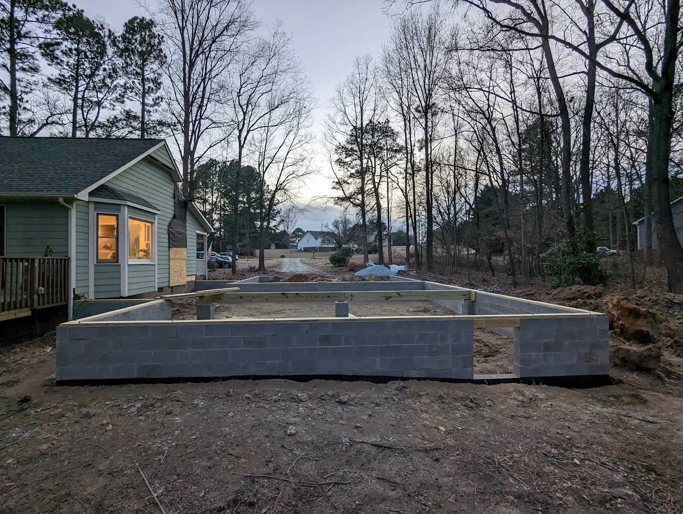Outdoor concrete footing foundation next to a house