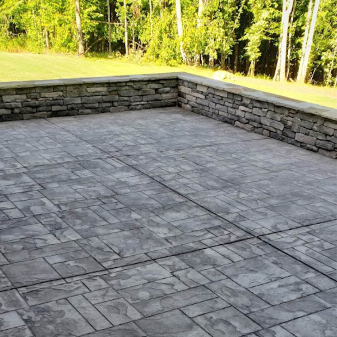 Stamped concrete patio with stone kneewall